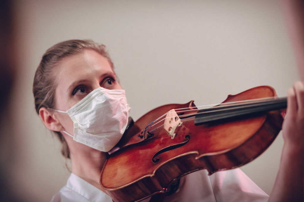 First, Do No Harm performer Julie Rooney conducting surgery through her viola. Photo by DW Burnett.